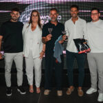 Des joueurs de football et de padel célébrant une victoire sur un terrain de padel, fusionnant les deux sports.